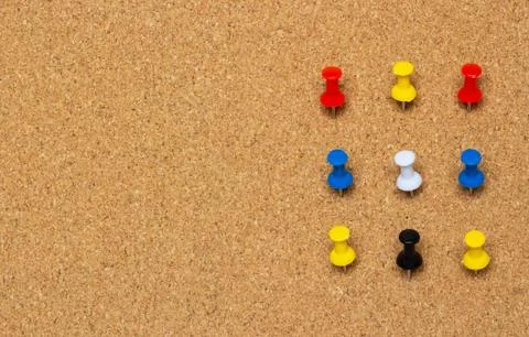Nine colored pinned button on a cork board Fotos Stock