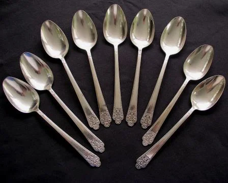 Nine Shiny Silver Spoon Set in a Semi Circle Stock Photos