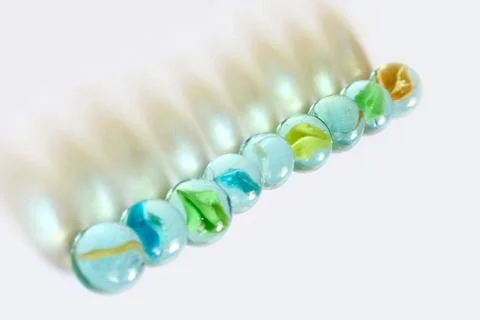 Nine zero round glass marbles on white background Foto stock