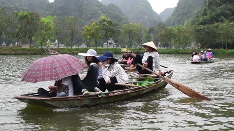 Ninh Binh, Vietnam, 04.29.2018: Vietnamese people rowing with their feet Stock Footage 144909341