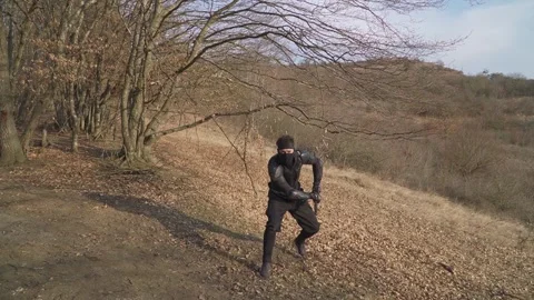 Ninja in Action: Precision Strike in Outdoor Training Stock Footage 307843596