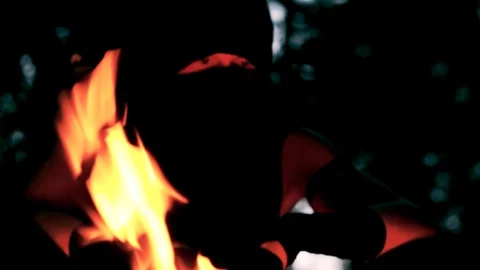Ninja sitting by a fire Stock Footage 95500347