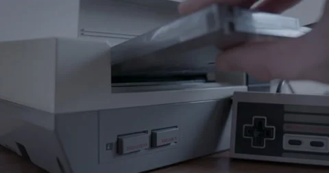 Nintendo Entertainment System with Controller and Game Cartridge Stock Footage 153817968