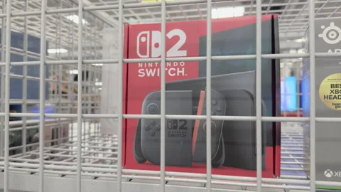 Nintendo Switch 2 console locked in cage at store 4k Stock Footage 332528290