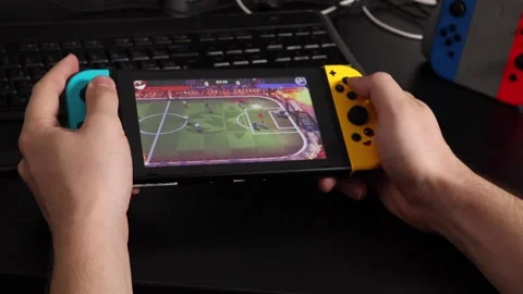 Nintendo switch grip controller is held in the hands of a guy. Stock Footage 219565122