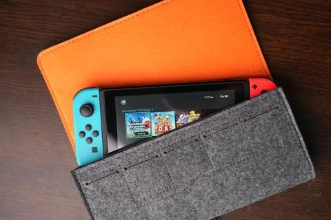 A Nintendo Switch handheld console in its original case Stock Photos