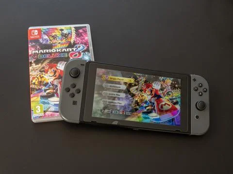 Nintendo Switch handheld wireless portable play console with Mario Stock Photos
