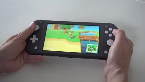 Nintendo Switch Lite playing a game. Stock Footage 131559750