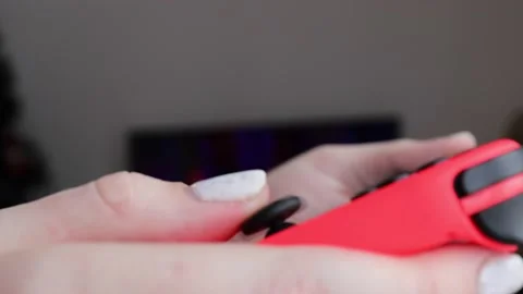 Nintendo Switch OLED game console with neon Joy-Cons. Stock Footage 229461627