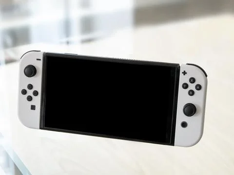Nintendo Switch  OLED Model in handheld mode. Popular mobile gaming console Stock Photos