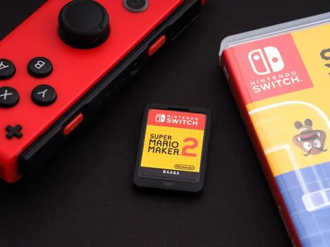 Nintendo Switch Super Mario Maker 2 video game cartridge , game box and red   Stock Photos