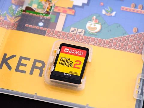 Nintendo Switch Super Mario Maker 2 video game cartridge inside game box. Stock Photos
