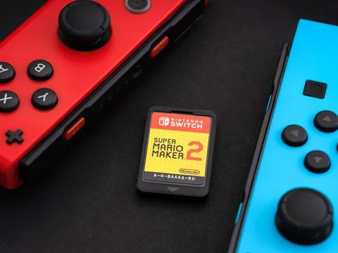 Nintendo Switch Super Mario Maker 2 video game cartridge and two Joy-Cons on  Stock Photos