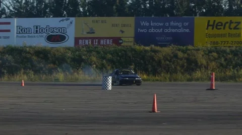 Nissan Maxima does huge drift around corner in slow motion at drifting event. Video stock 59747417