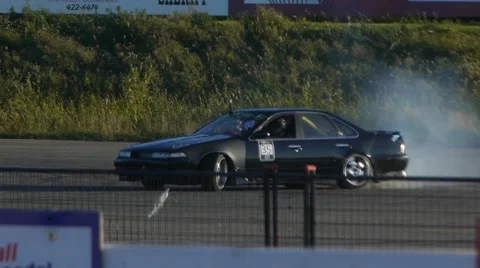 Nissan Maxima drifting around corner on closed course at drift practice event. Video stock 59747441