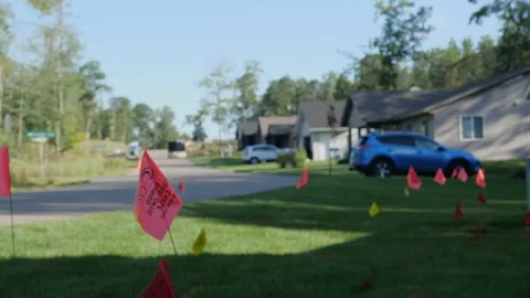 NISSWA, MN  25 AUG 2022: Warning flags on residential lawn. Stock Footage 219692353