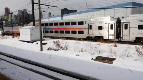 NJ Transit double decker commuter train passing with snow on the ground Stock Footage 148456915