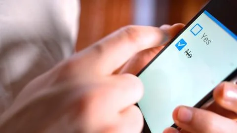 No checkbox vote button on the screen mobile phone. Hand push checkbox NO Fotos de archivo