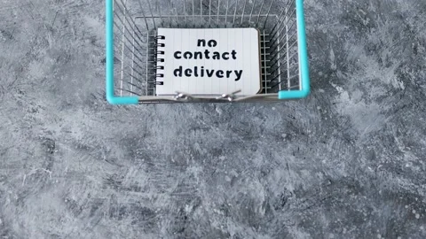 No Contact Delivery text on notepad inside shopping basket symbol of purchase Stock Footage 134218949