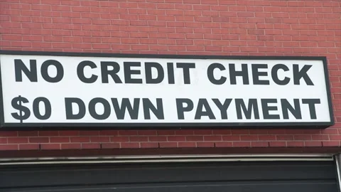 No credit check 0 zero dollar down payment sign outside on wall above garage Stock Footage 249102317