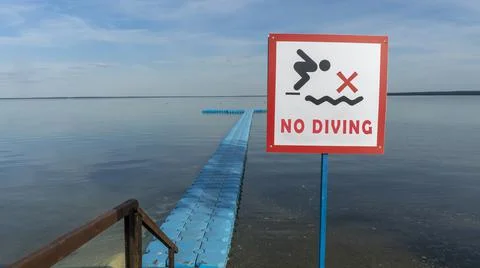 No Diving sign at beach, lake Naroch, Belarus. Warning sign of shallow water. Stock Photos