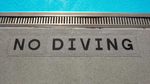 'No Diving' Warning Sign On The Ground by a Swimming Pool Stock Footage 114136560
