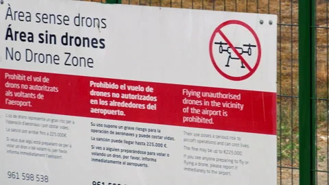 No drone zone warning sign on fence at Valencia Airport with Aena logo Stock Footage 344971271