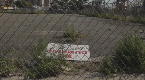 No dumping sign fallen on the ground in vacant lot Stock Footage 63298787