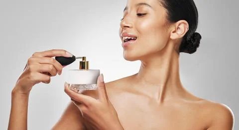 No elegance is possible without perfume. Studio shot of an attractive young Fotos Stock