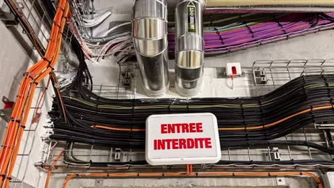 No entry sign in french on a server room door with electrical cables and pipes Stock Footage 341544162