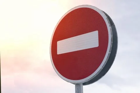 No Entry Sign at Sunset warns drivers in urban areas, ensuring safe traffic Stock Photos