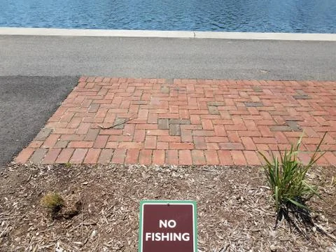 No fishing sign with red bricks and water Stock Photos