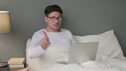 No Gesture with Finger by Middle Aged Man with Laptop in Bed 스톡 동영상 142365531