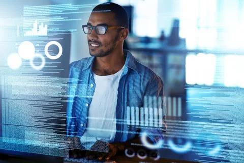 No glitches in this code. Shot of a happy computer programmer working on new  库存照片