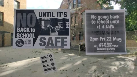 NO GOING BACK TO SCHOOL UNTIL IT'S SAFE COVID WARNING ON BUS STOP 4K Stock Footage 130916588