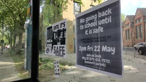 NO GOING BACK TO SCHOOL UNTIL IT'S SAFE FLYER ON BUS STOP COVID-19 Stock Footage 130916599