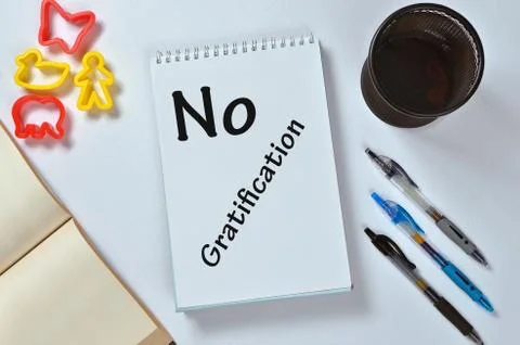No gratification text on notepad with office accessories. Business motivation Stock Photos