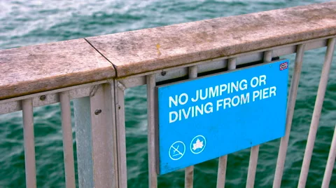 No Jumping or Diving From Pier sign in Coney Island New York during Summer Video stock 63657947