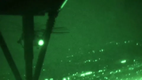No light imagery of U.S. Marines CH-53 Super Stallion helicopter flying at night Stock Footage 257891107