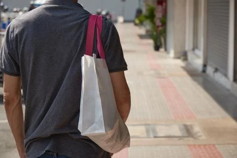 No more plastic. A man using cloth bag for shopping. Stock Photos
