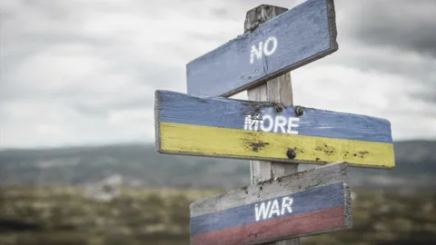 No more war text quote on wooden signpost outdoors on nato colored flag, ukra Video stock 171028406