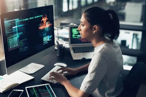 No one blocking this shine. a young woman using a computer in a modern office. Stockfoto's