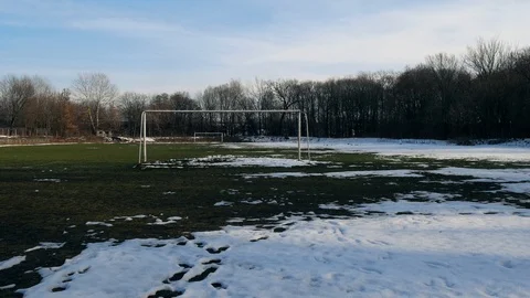 No one, deserted lone stadium in the snow and mud after winter Stock Footage 112076757