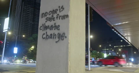 No one is safe from climate change - inscription in downtown at cars traffic Stock Footage 231990419