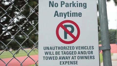 No parking anytime unauthorized vehicles will be tagged and or towed away Stock Footage 247748932