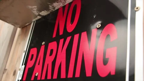 No parking horizontal rectangle sign fastened to wood fence of wood color, red Stock Footage 247143472