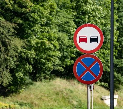 No Parking or Overtaking Allowed Road Sign in Front of Green Trees Stock Photos