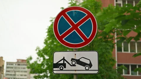 No parking sign with red circle and blue cross symbol, accompanied by towin.. 動画素材 344460099