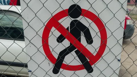 No pedestrians Font, pattern, symbol on a fence by the asphalt road surface Stock Footage 272449887