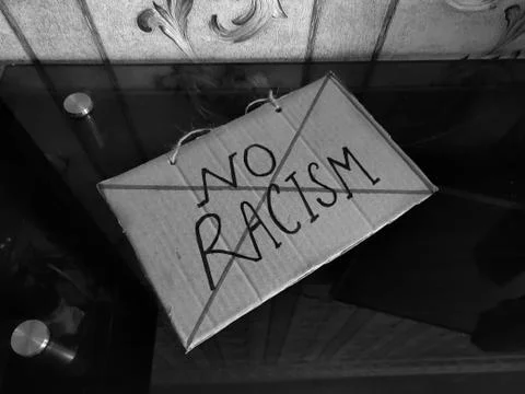 No racism poster kept on desk. Stock Photos